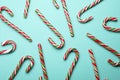 Many sweet Christmas candy canes on turquoise background, flat lay Royalty Free Stock Photo