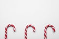 Many sweet Christmas candy canes on white background, flat lay. Space for text Royalty Free Stock Photo