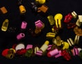 Many sweet and colourful candies are falling down to the table