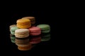 Many sweet macarons on the black surface Royalty Free Stock Photo