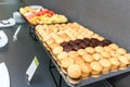 Many Sweet muffins and sliced fruits on table on a coffee break in the office Royalty Free Stock Photo