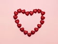 Many sweet red candies heart shaped isolated