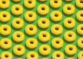 Many Sweet Tasty Donuts With Yellow Glaze And Sprinkles Over Green Background