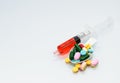 Many tablets and pill on spoon and liquid drug in syringe Royalty Free Stock Photo