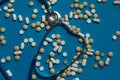 Many Tablets And Stethoscope Lies On Blue Surface, Top View. Medicine Creativity Concept