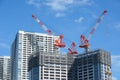 Many tall buildings under construction and cranes under a blue sky Royalty Free Stock Photo