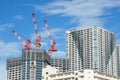 Many tall buildings under construction and cranes under a blue sky Royalty Free Stock Photo