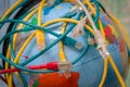 Many of tangled internet wires entangle around the globe. A messy cable plexus is on the world map. The Internet network covers Royalty Free Stock Photo