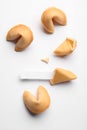 Many tasty fortune cookies with predictions on white background, flat lay. Space for text Royalty Free Stock Photo