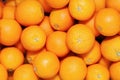 Many tasty ripe orange mandarins are piled on counter at the farmers market. New Year fruit concept, fresh squeezed vitamin juice