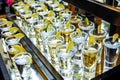 Many tequila glasses with lemon and cactus