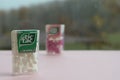 Many Tic Tac Candy packages on green wood background. Tic tac is popular due its minty fresh taste and easy to carry. Hard mints