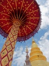Many-tiered umbrella with chedi or pagoda background in Wat Phra That Hariphunchai in Lamphun, Thailand Royalty Free Stock Photo