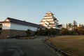 Many tourism walk around white Samurai castle of Japan in Evening of Winter season