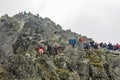 Many tourists despite the poor weather on the way to the popular Rysy peak. Tatra Mountains.