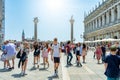 Many tourists visiting Piazzetta San Marco (St Marks Square) and Colonna di San Marco in Venice Royalty Free Stock Photo