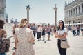 Many tourists visiting Piazzetta San Marco (St Marks Square) and Colonna di San Marco in Venice Royalty Free Stock Photo