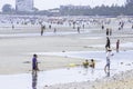 Many tourists walk on the beach and garbage on the coast at low tide Background sea and large buildings at Bangsaen Beach,