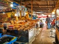 Many tourists are walking shopping in Ban Samaesarn seefood market,located in Sattahip District