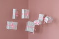 Many traditional gift boxes are falling on pink background