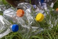 Many transparent empty water bottles are gathered in the paper bag on the green grass. Royalty Free Stock Photo