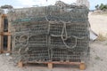 many traps stacked up in a row on pallets with ropes