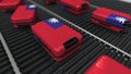 Many travel suitcases featuring flag of Taiwan on roller conveyer. Taiwanese tourism conceptual 3D rendering Royalty Free Stock Photo