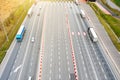 Many trucks are moving along the highway crossing road between the fields. drone view Royalty Free Stock Photo