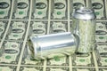 Many two dollar bills and blank cans of beverage Royalty Free Stock Photo