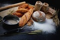 many type of bread studio shot with . ingredients flour seed grain all around.photo take with high iso may has some noise and gai