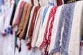 Many Ukrainian national clothes - embroidered shirts hang on counter, sold in the market Royalty Free Stock Photo