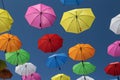 many umbrellas are in the air for viewing as people walk by Royalty Free Stock Photo