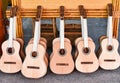 Many unfinished wooden drying guitars in workshop
