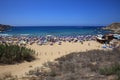 Many unidentified People at the Beach of Golden Bay in Malta