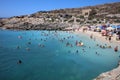 Many unidentified People on the Beach of Hondoq Bay. Island of Gozo. Malta