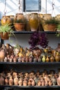 Many unique handmade colorful clay jugs and vases of various shapes on shelf in local Turkey market