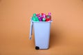 Many used batteries in recycling bin on coral background Royalty Free Stock Photo