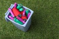Many used batteries in recycling bin on green grass, above view. Space for text Royalty Free Stock Photo