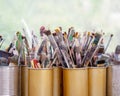 Many used different colorful artist brushes in different sizes are collected and stored in metal boxes, copy space Royalty Free Stock Photo