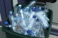 Many used plastic bottles in trash bin outdoors, closeup. Recycling problem Royalty Free Stock Photo