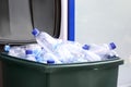 Many used plastic bottles in trash bin outdoors, closeup. Recycling problem Royalty Free Stock Photo