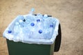 Many used plastic bottles in trash bin outdoors, closeup. Recycling problem Royalty Free Stock Photo