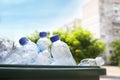 Many used plastic bottles in trash bin outdoors, closeup. Recycling problem Royalty Free Stock Photo