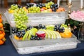 Many useful fruits of grapes, apples, grapes, oranges. The concept is healthy food, party, buffet, catering.