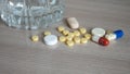 Close-up of various pills and a glass of water on the table Royalty Free Stock Photo