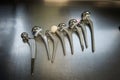 various explanted hip joint prostheses lying next to each other on the table Royalty Free Stock Photo
