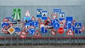 Many Various Road Signs On Grey Corrugated Metal Background