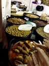 Many very big barrels of various kinds of olives, other vegetable and salted fish at an outdoor Spanish market Royalty Free Stock Photo