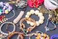 Many vintage old-fashioned jewelry at flea market stall or car boot sale. Retro style bracelets and necklaces Royalty Free Stock Photo
