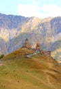 Many of visitors climbing up to the iconic Gergeti Trinity Church, Stepantsminda town, Kazbegi, Georgia